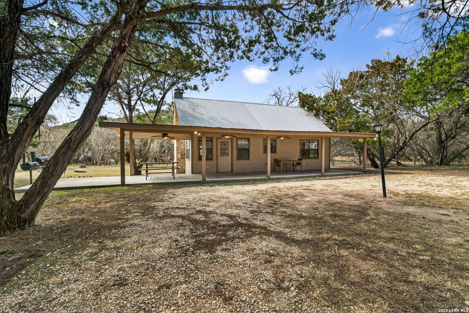 15 Cedar Lane Concan, TX 78838 - Photo 7 of 50 front view of a house with a yard