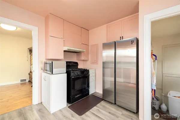 a kitchen with a refrigerator and a refrigerator