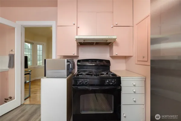a stove top oven sitting inside of a kitchen