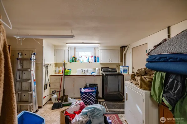 a kitchen with a refrigerator and a stove top oven
