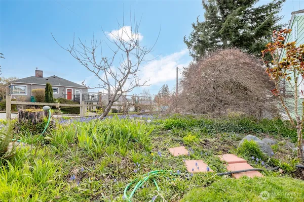 a front view of a house with a yard and fountain in middle