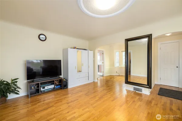 a living room with a flat screen tv and a large window