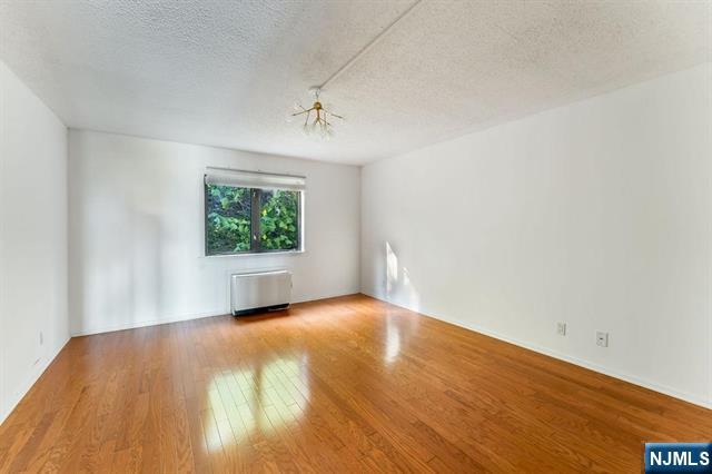 1150 River Road, Unit 4F Edgewater, NJ 07020 - Photo 12 of 22 wooden floor in an empty room