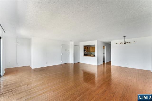 1150 River Road, Unit 4F Edgewater, NJ 07020 - Photo 10 of 22 a view of an empty room with wooden floor and a window