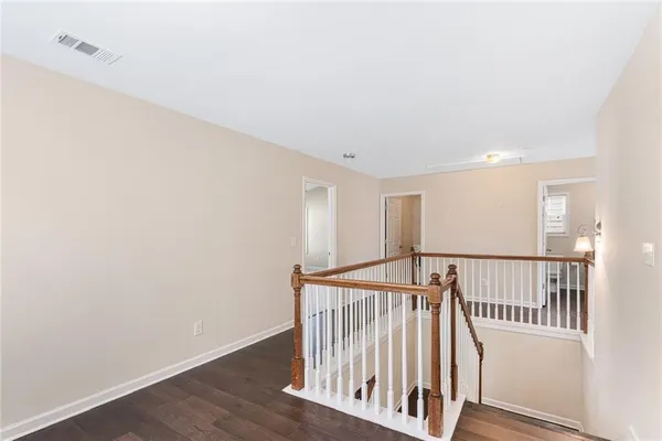 a view of hallway with wooden floor