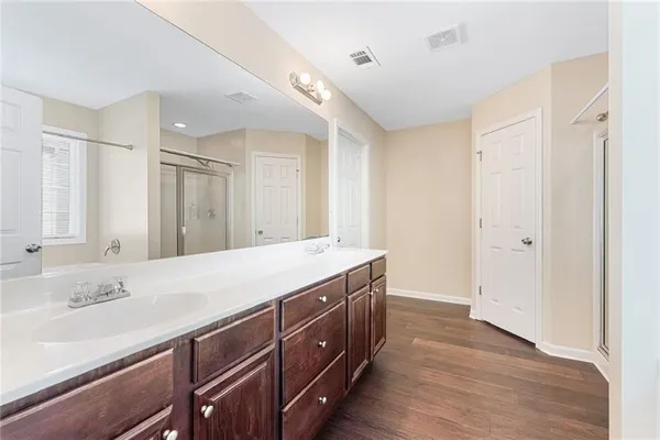 a spacious bathroom with a granite countertop sink and a mirror
