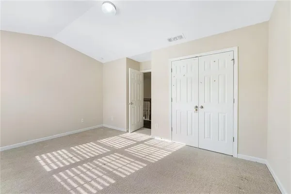 a view of a room with wooden floor and closet
