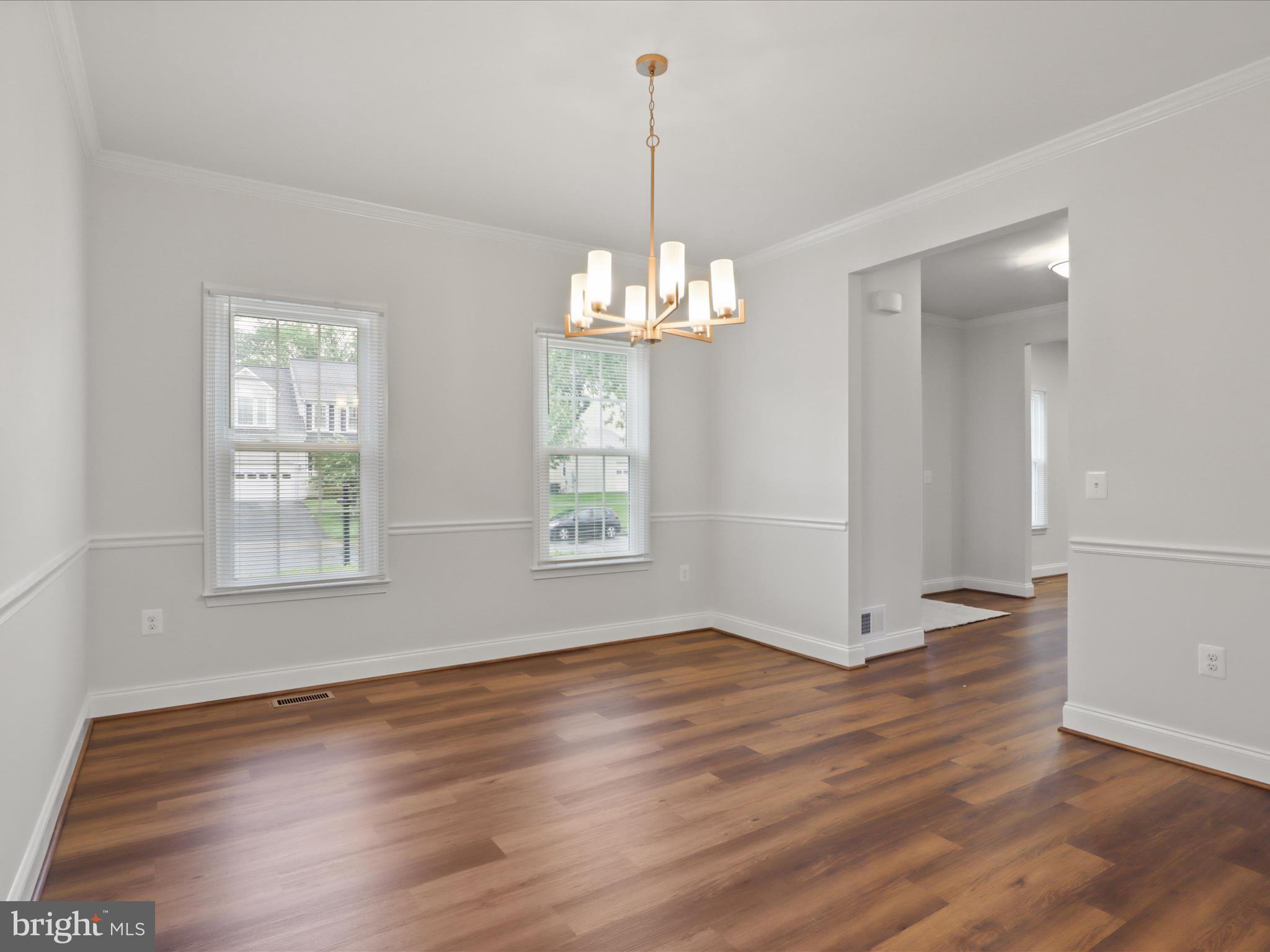 9365 River Crest Road Manassas, VA 20110 - Photo 11 of 62 an empty room with wooden floor and windows