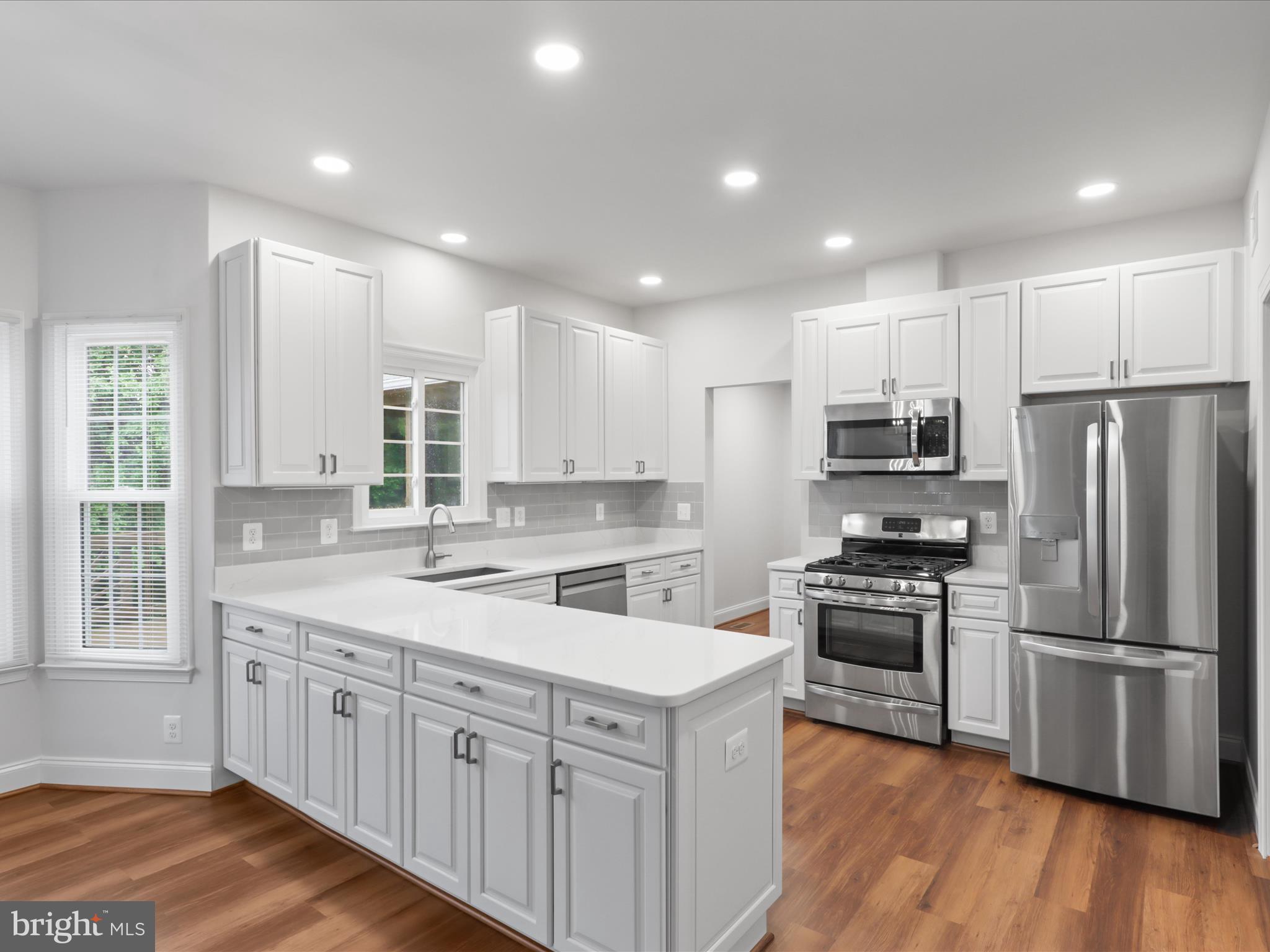 9365 River Crest Road Manassas, VA 20110 - Photo 13 of 62 a kitchen with stainless steel appliances granite countertop a sink stove and refrigerator