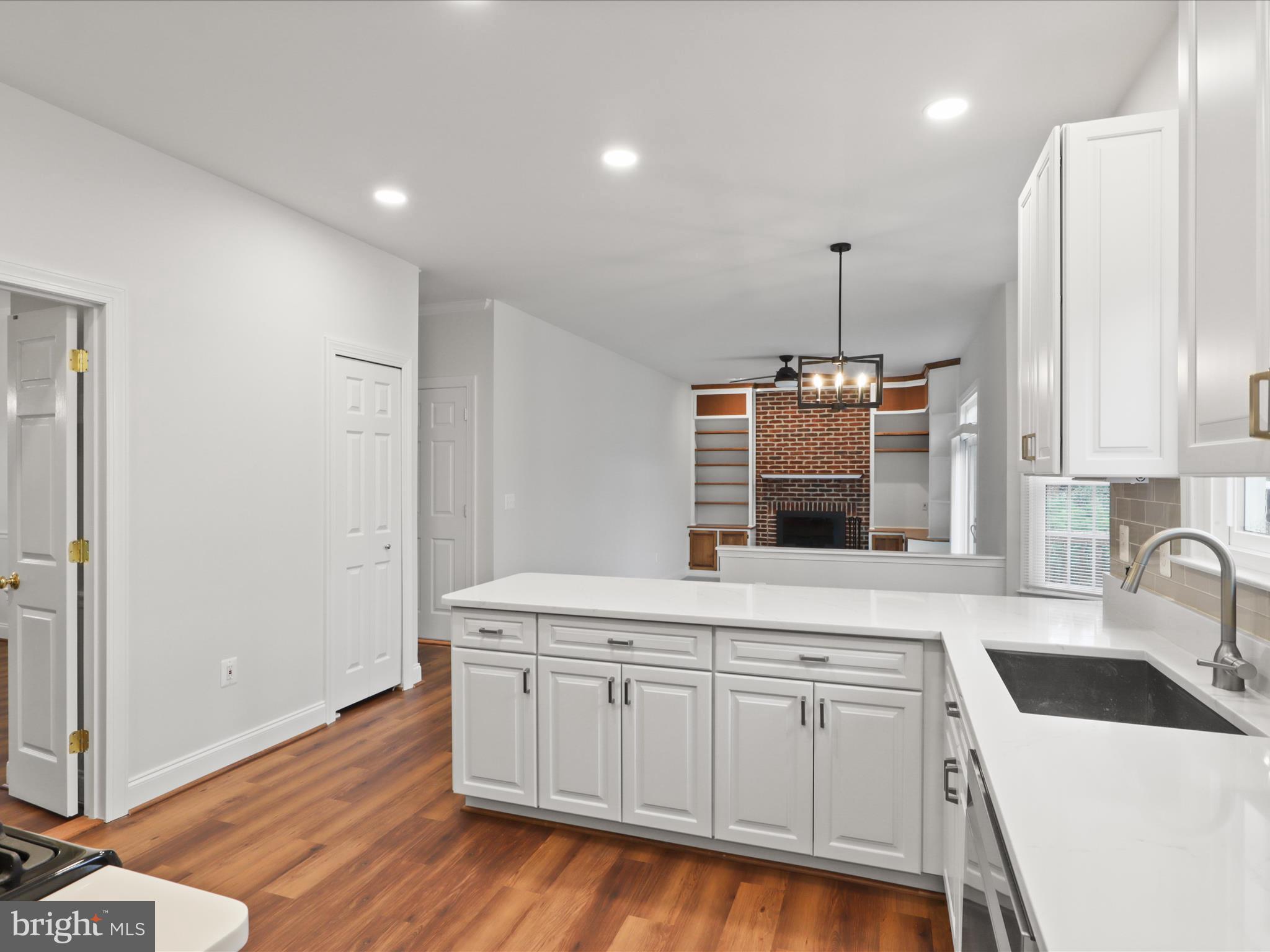 9365 River Crest Road Manassas, VA 20110 - Photo 14 of 62 a kitchen with a sink a counter space appliances and cabinets