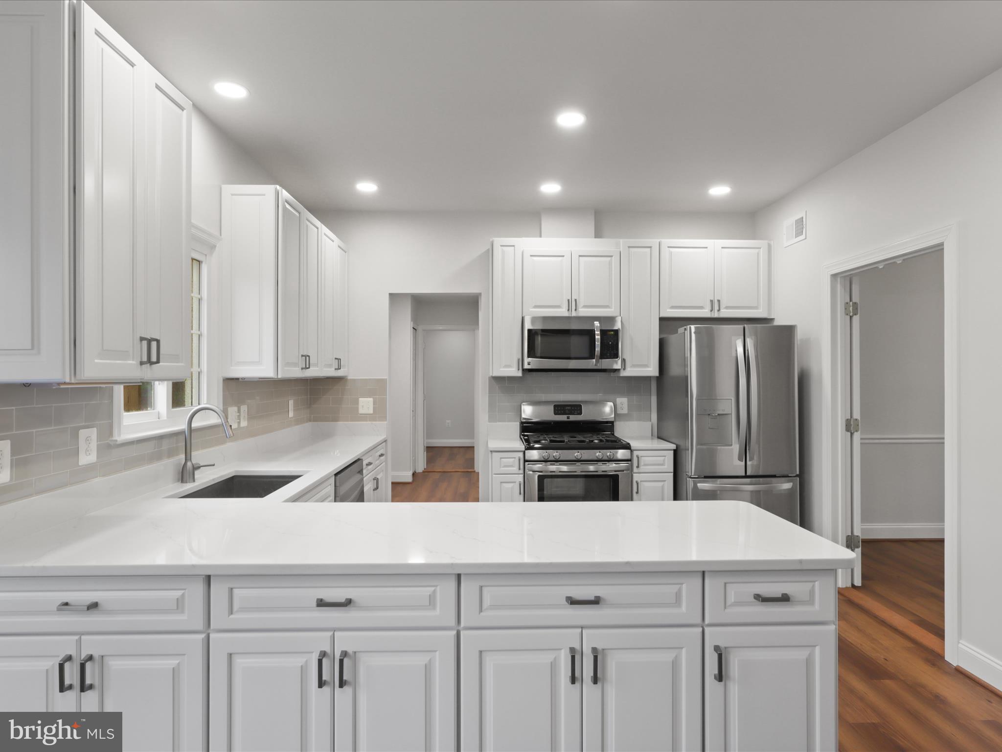 9365 River Crest Road Manassas, VA 20110 - Photo 15 of 62 a kitchen with appliances a sink and cabinets