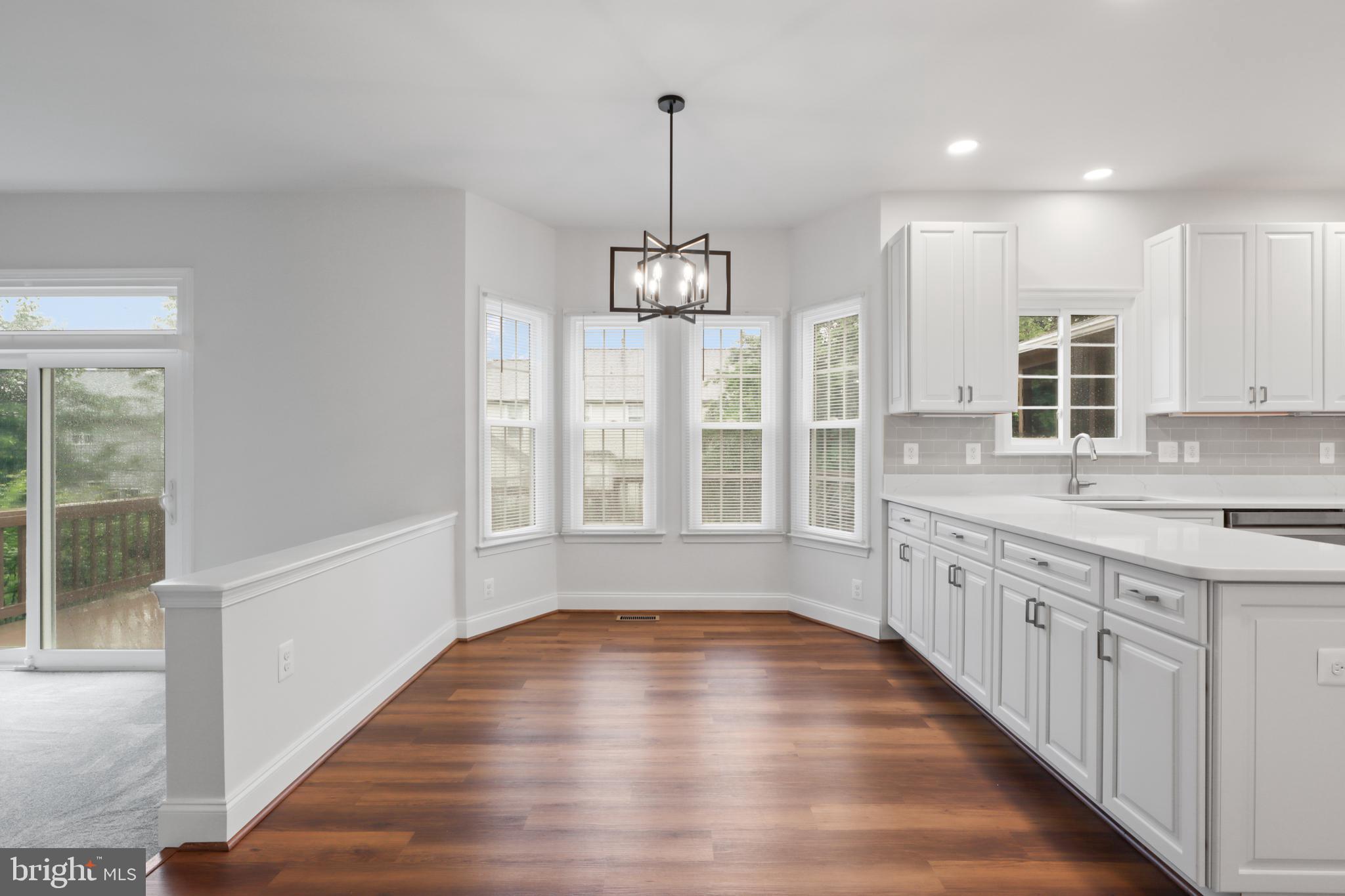 9365 River Crest Road Manassas, VA 20110 - Photo 17 of 62 a view of a kitchen with wooden floor and a window