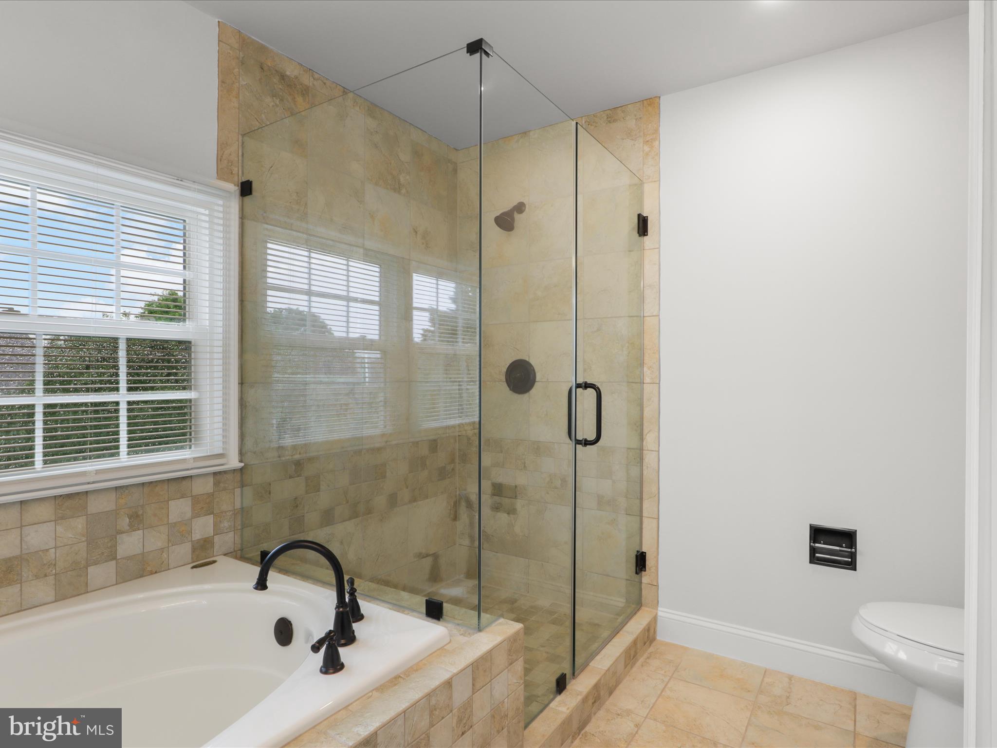 9365 River Crest Road Manassas, VA 20110 - Photo 33 of 62 a bathroom with a tub and a shower
