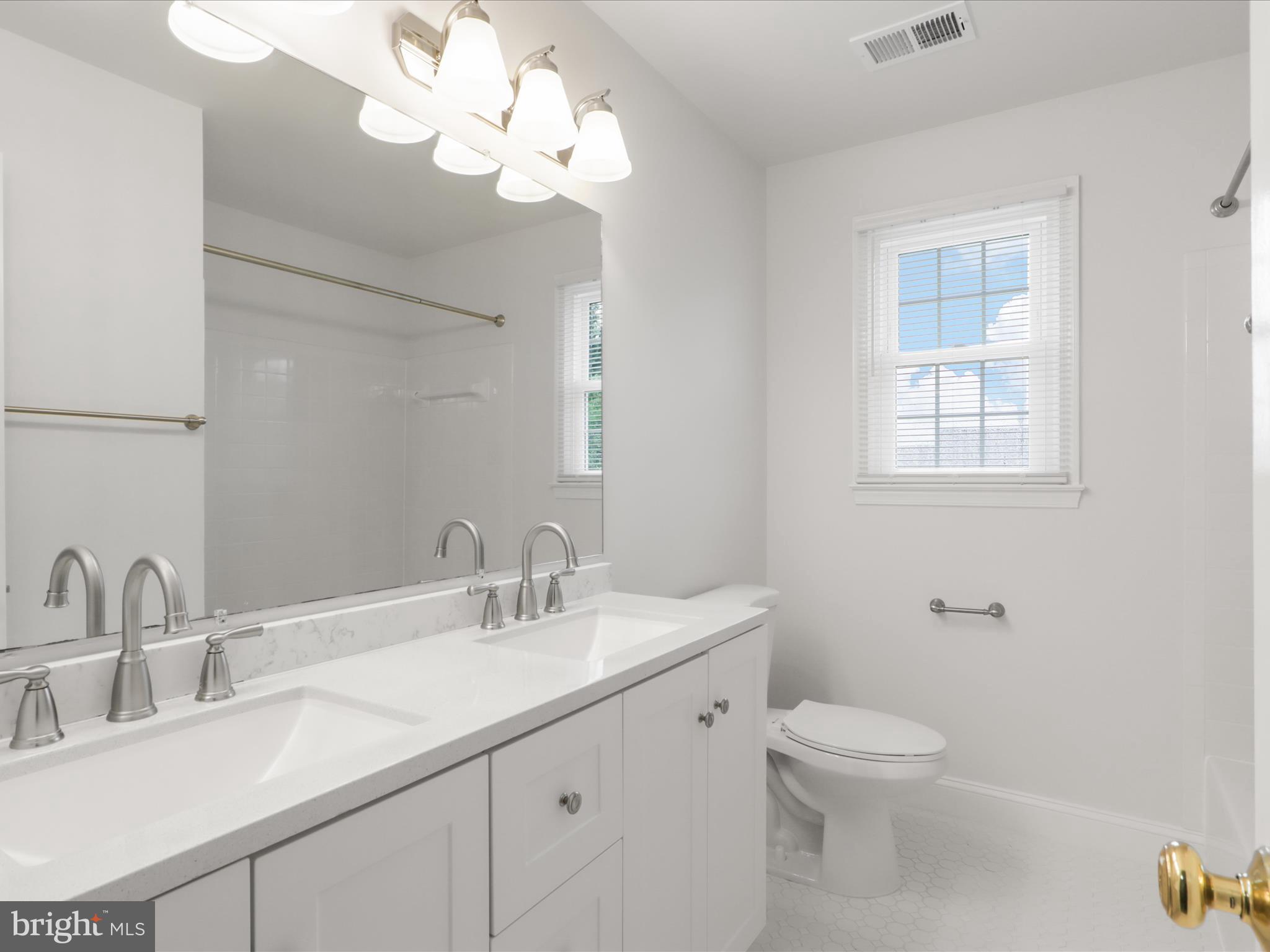 9365 River Crest Road Manassas, VA 20110 - Photo 34 of 62 a bathroom with a sink a toilet and a mirror