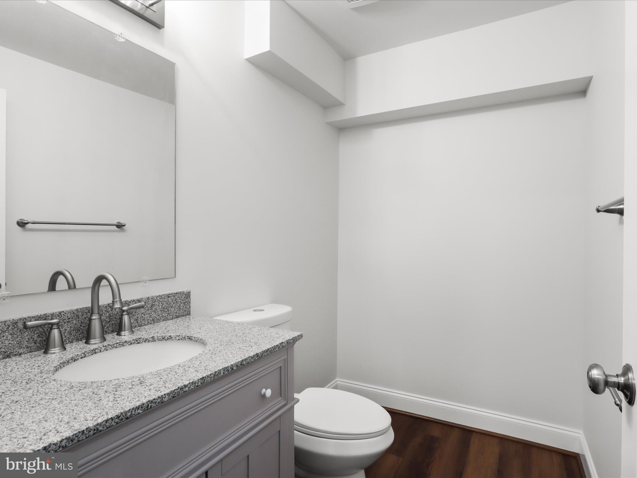 9365 River Crest Road Manassas, VA 20110 - Photo 43 of 62 a bathroom with a granite countertop sink toilet and a mirror