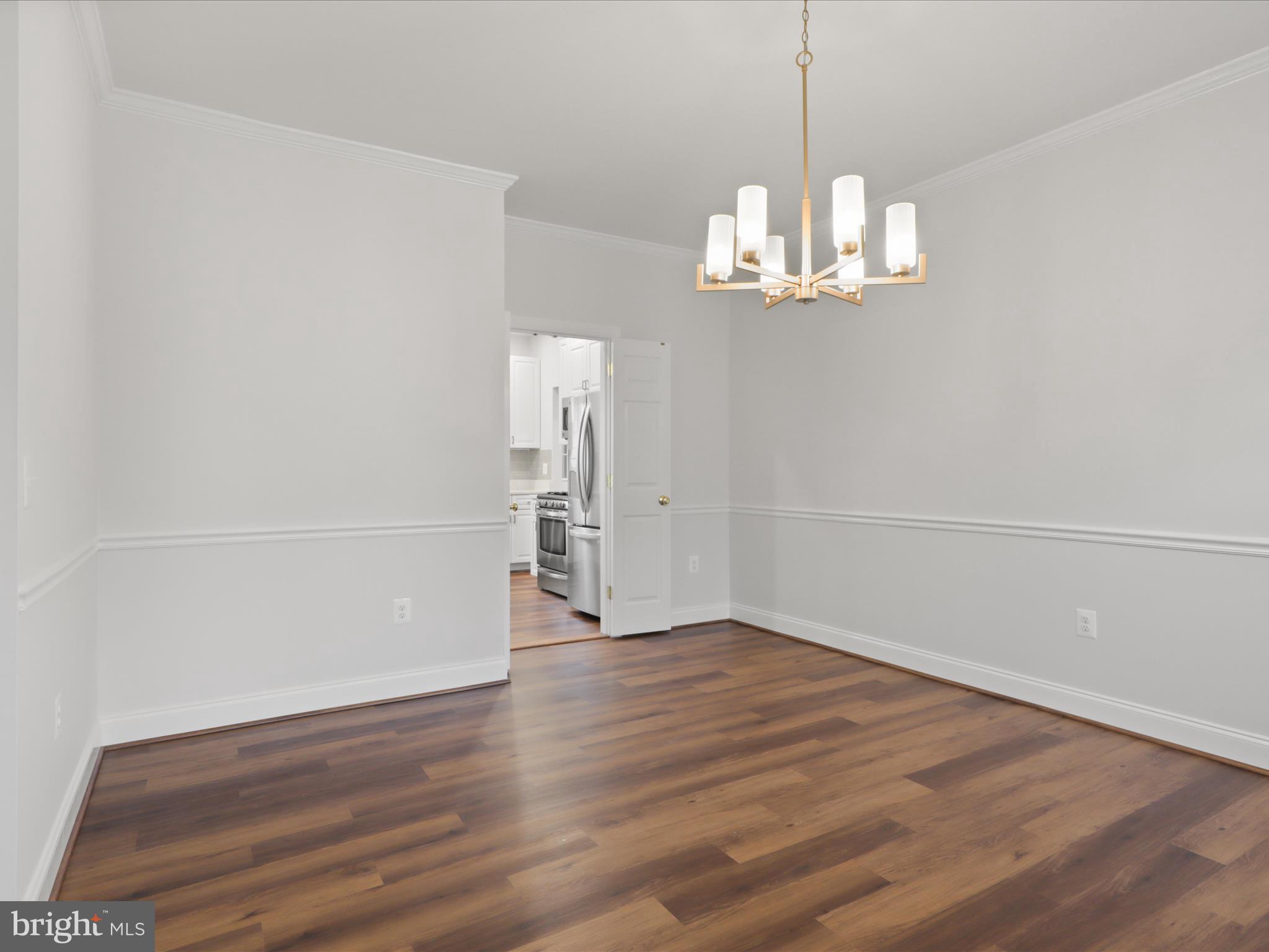 9365 River Crest Road Manassas, VA 20110 - Photo 10 of 62 a view of empty room with wooden floor and ceiling fan