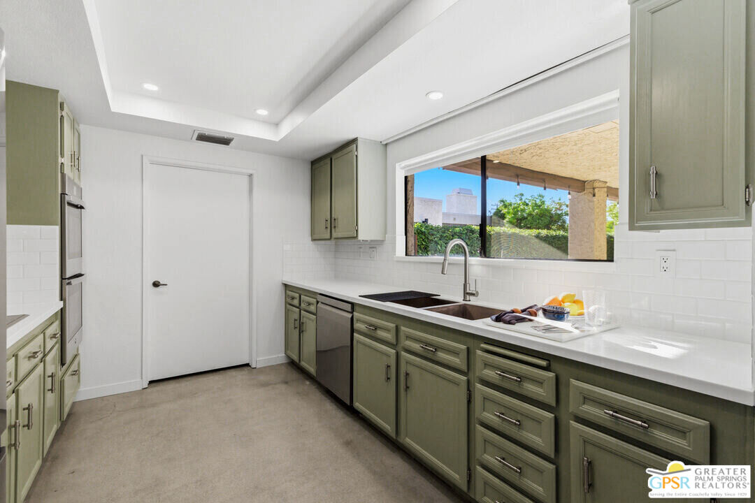20 Kevin Lee Lane Rancho Mirage, CA 92270 - Photo 11 of 40 a kitchen with stainless steel appliances a sink stove and cabinets