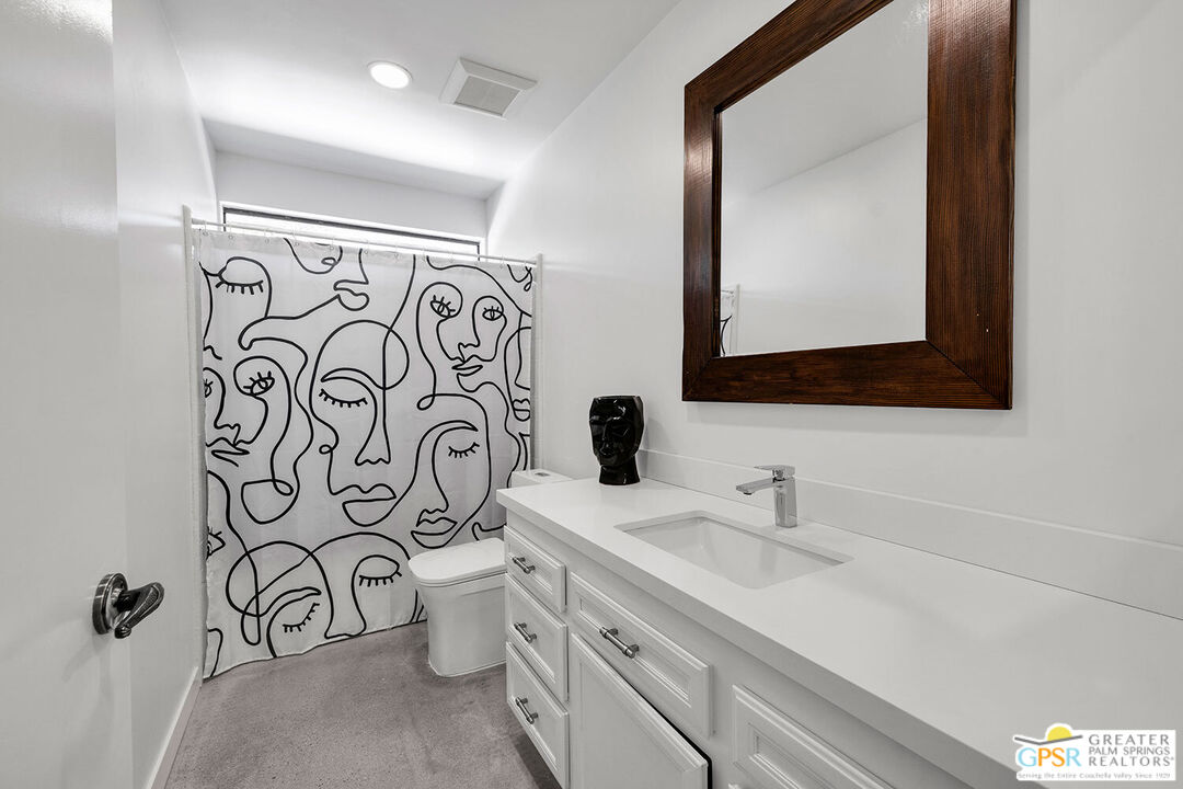 20 Kevin Lee Lane Rancho Mirage, CA 92270 - Photo 24 of 40 a bathroom with a toilet sink mirror and vanity