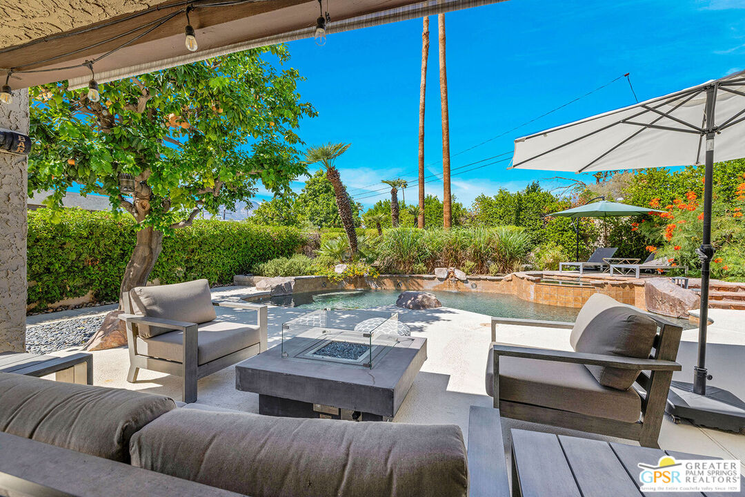 20 Kevin Lee Lane Rancho Mirage, CA 92270 - Photo 26 of 40 a view of a patio with couches table and chairs under an umbrella