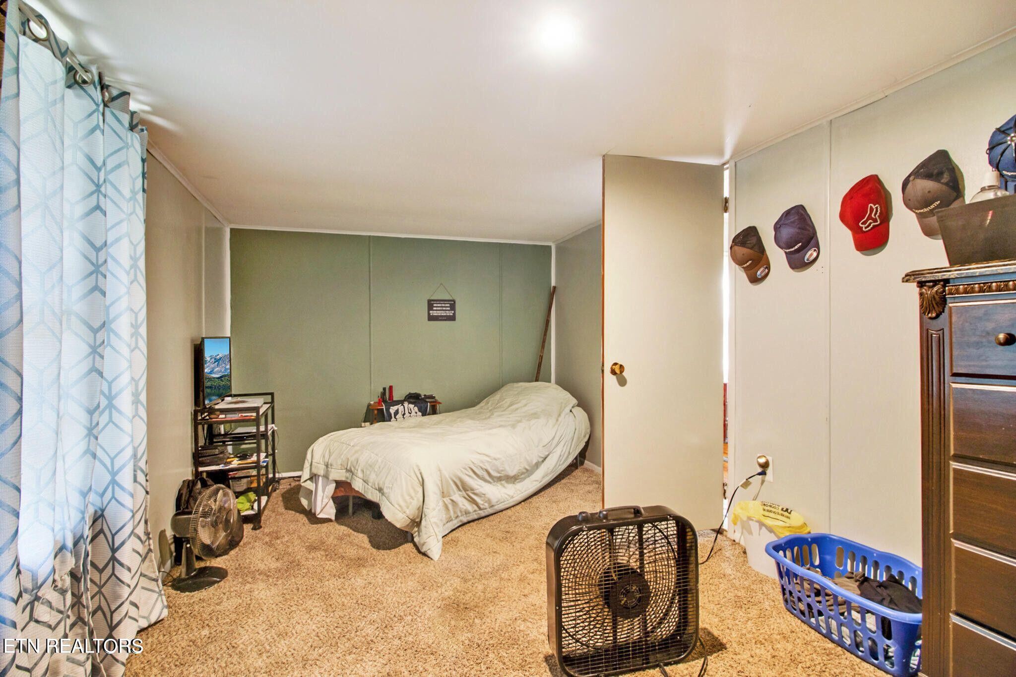 700 Rugby Avenue Jamestown, TN 38556 - Photo 14 of 24 a bedroom with a bed and a cabinets