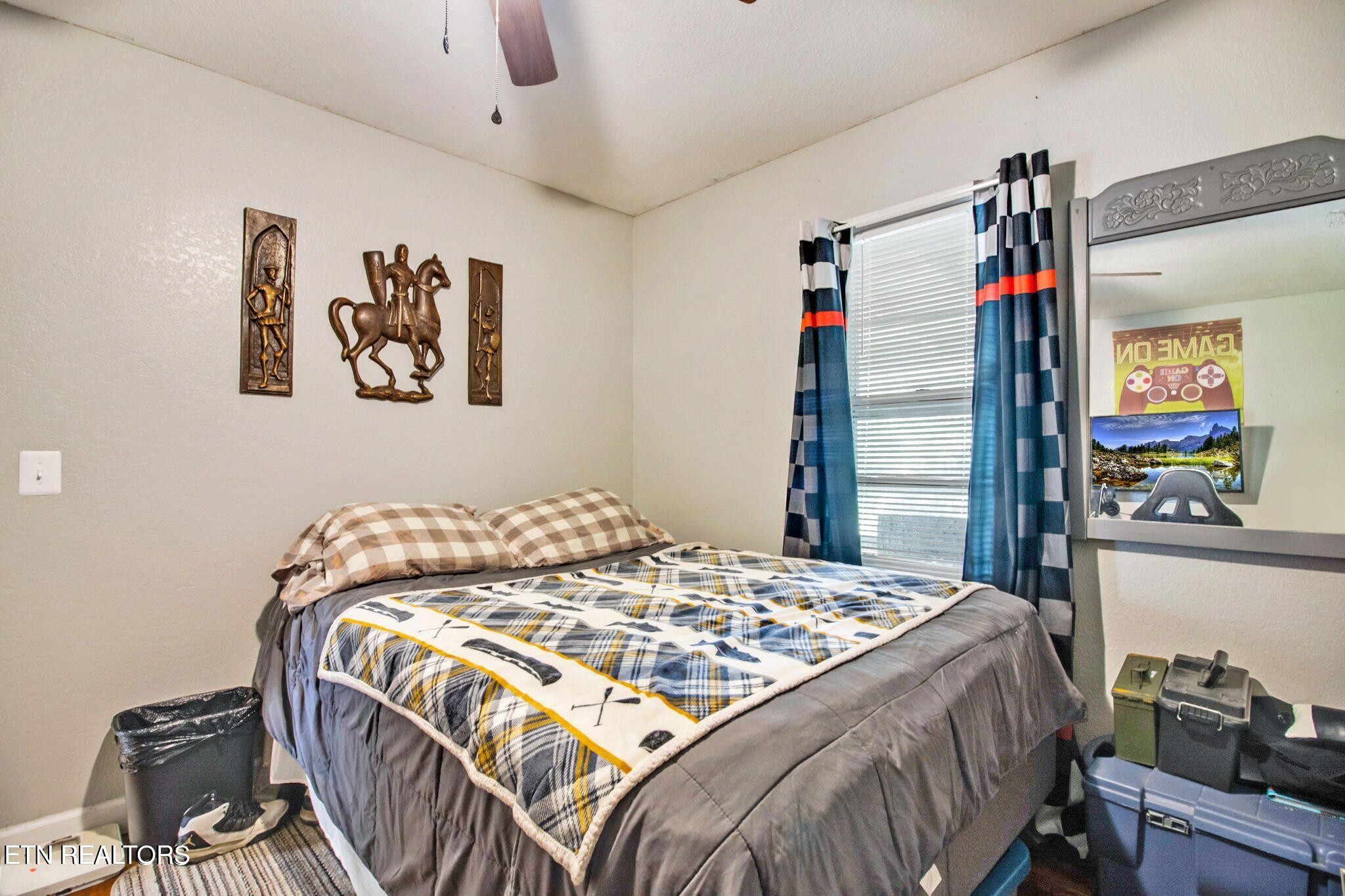 700 Rugby Avenue Jamestown, TN 38556 - Photo 22 of 24 a bedroom with a bed and painting on the wall