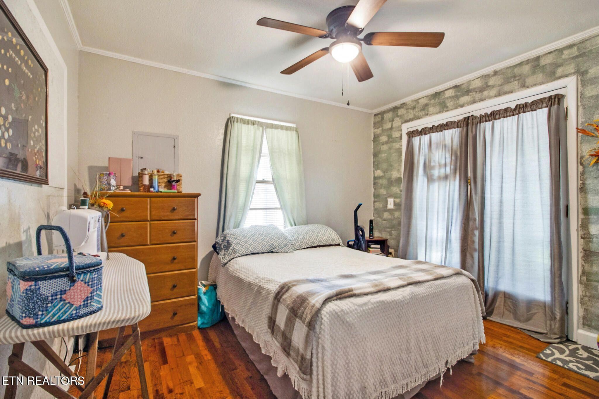 700 Rugby Avenue Jamestown, TN 38556 - Photo 23 of 24 a bedroom with a bed and wooden floor