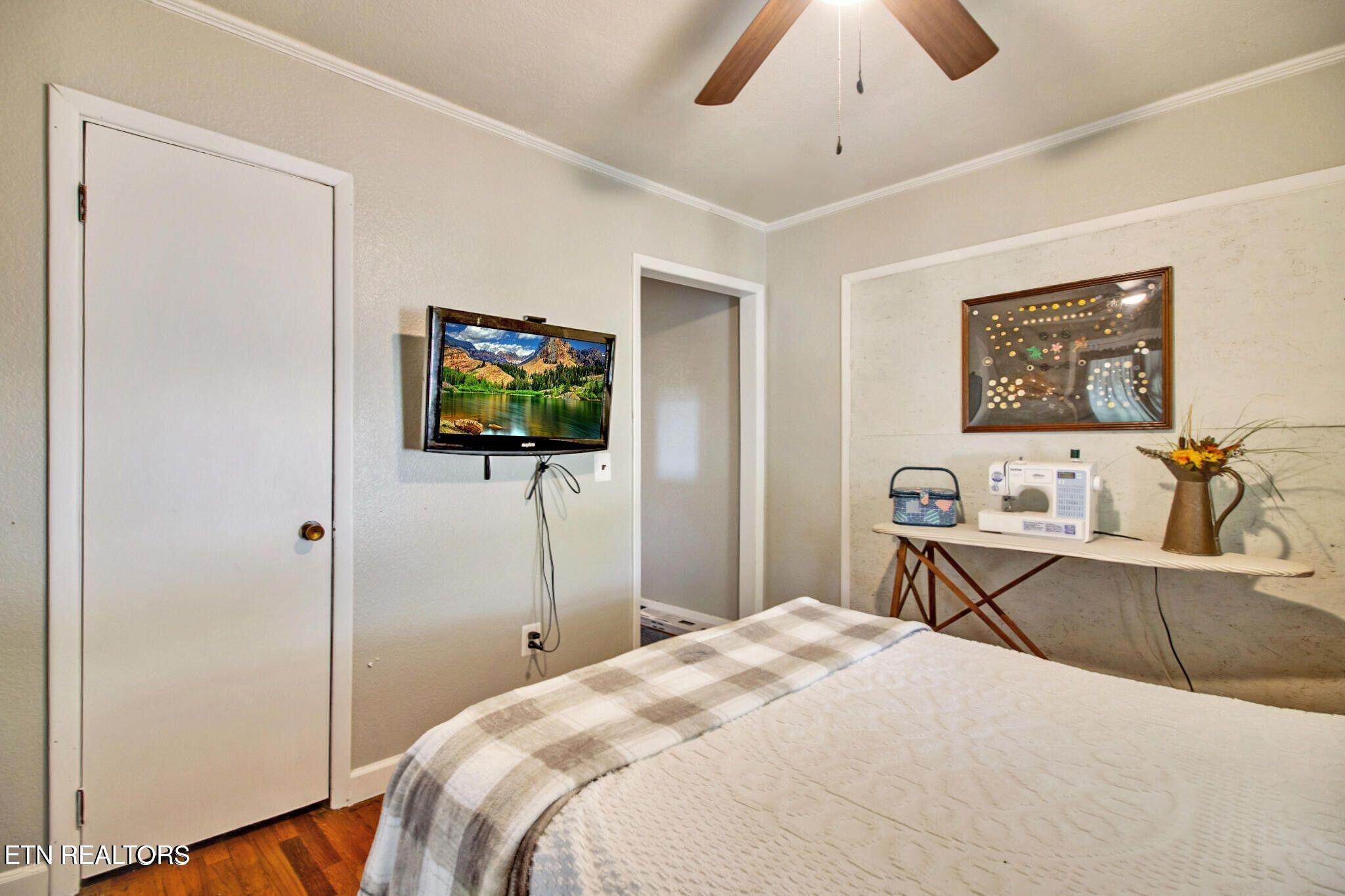 700 Rugby Avenue Jamestown, TN 38556 - Photo 24 of 24 a bedroom with a bed and a flat tv screen on dresser