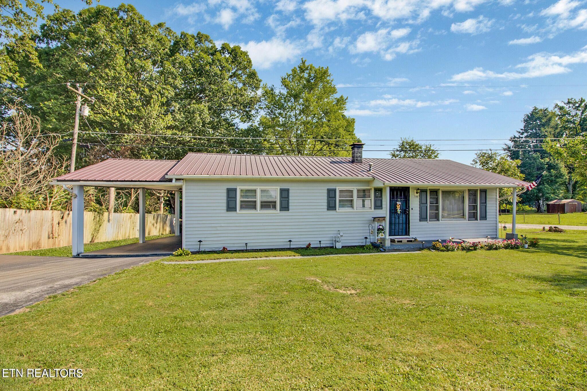 700 Rugby Avenue Jamestown, TN 38556 - Photo 3 of 24 a front view of a house with a garden