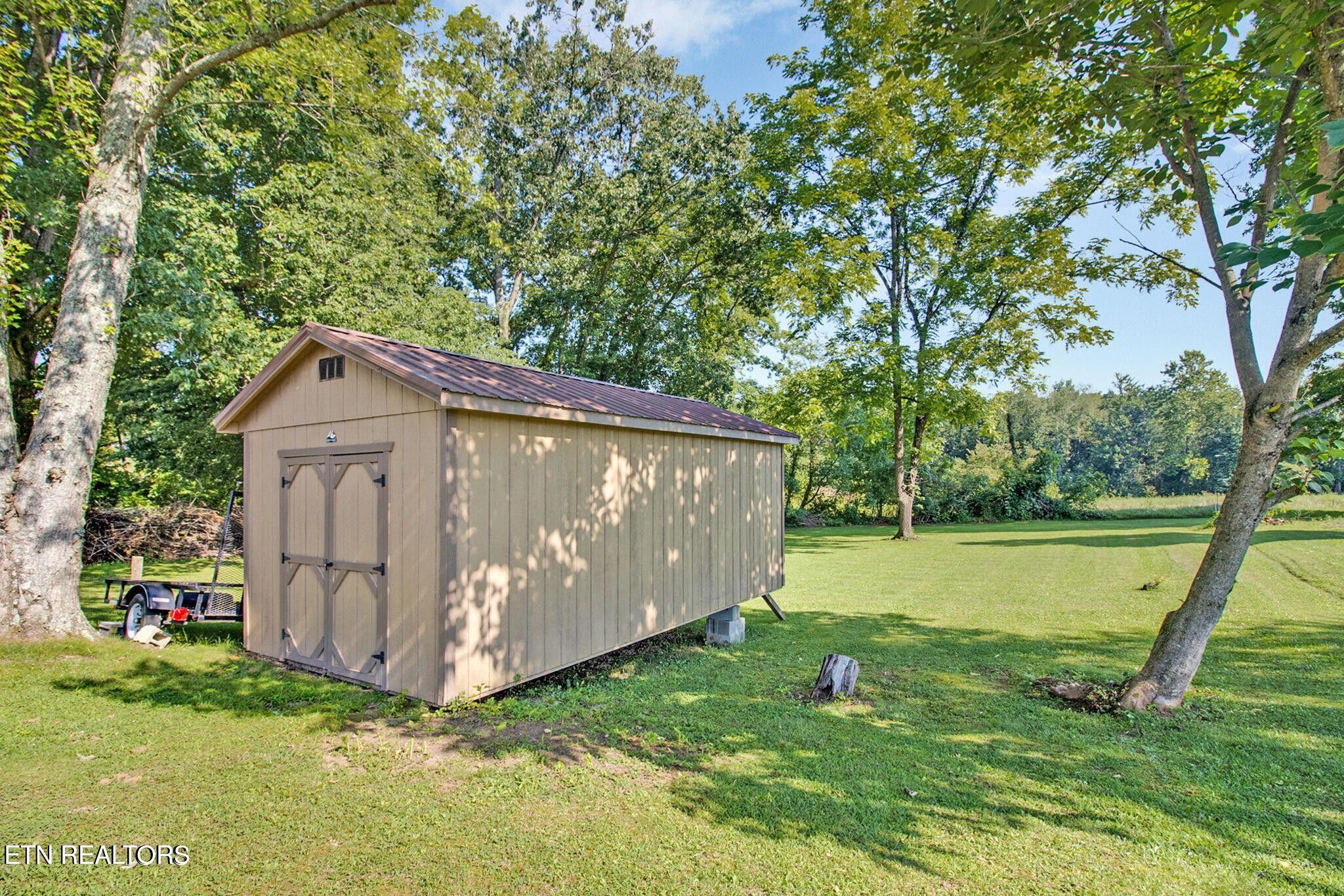 700 Rugby Avenue Jamestown, TN 38556 - Photo 8 of 24 a view of a backyard with a small cabin