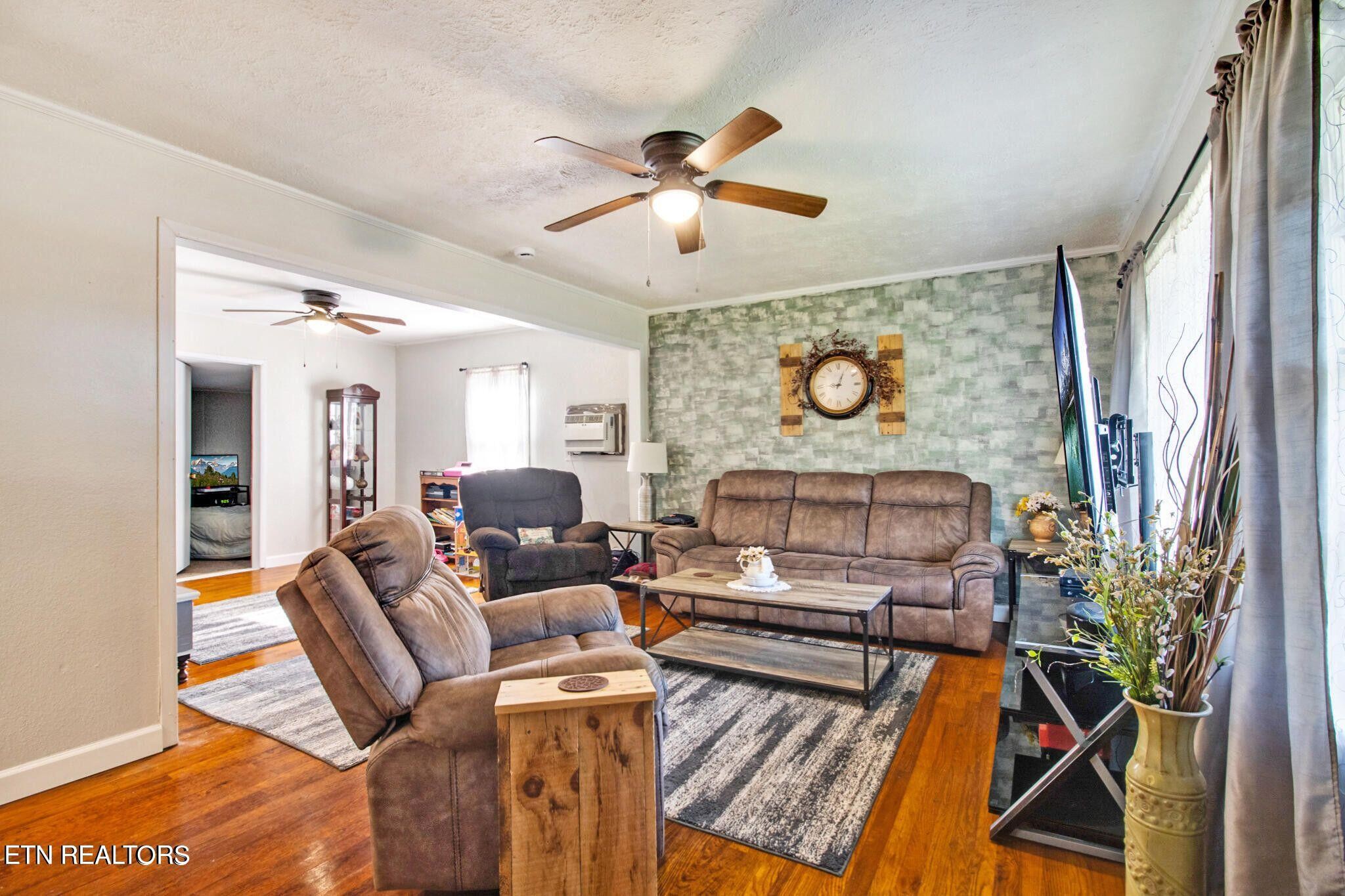 700 Rugby Avenue Jamestown, TN 38556 - Photo 10 of 24 a living room with furniture a chandelier and a window