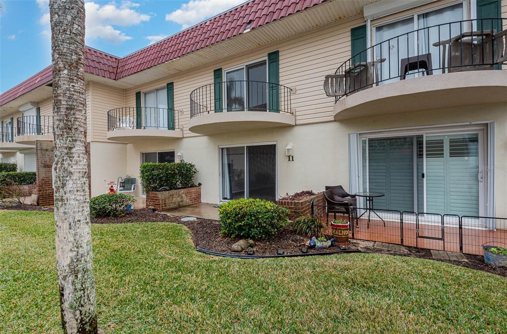 2810 Ocean Shore Boulevard, Unit 11 Ormond Beach, FL 32176 - Photo 1 of 1 a view of a house with a yard and sitting area