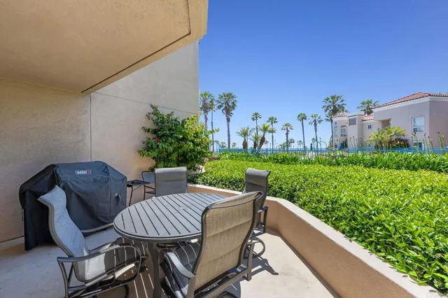 a view of a patio with table and chairs and potted plants