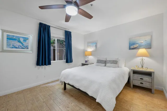 a bedroom with a bed and a lamp on the dresser