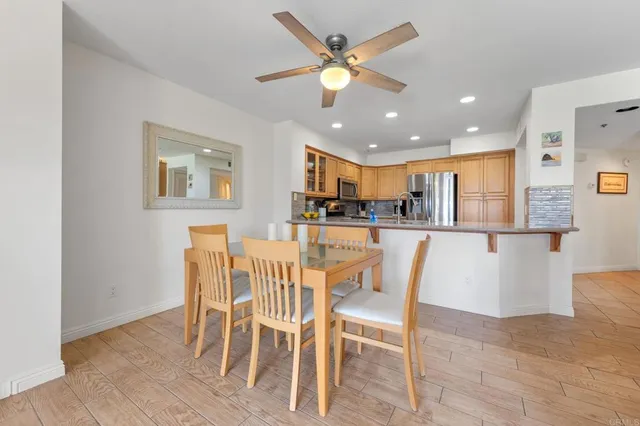 a dining room with furniture and a kitchen view