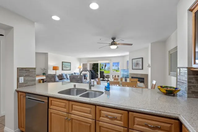 a kitchen with a sink appliances and cabinets