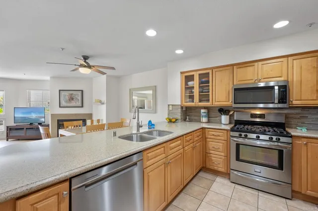 a kitchen with stainless steel appliances a stove sink microwave and cabinets