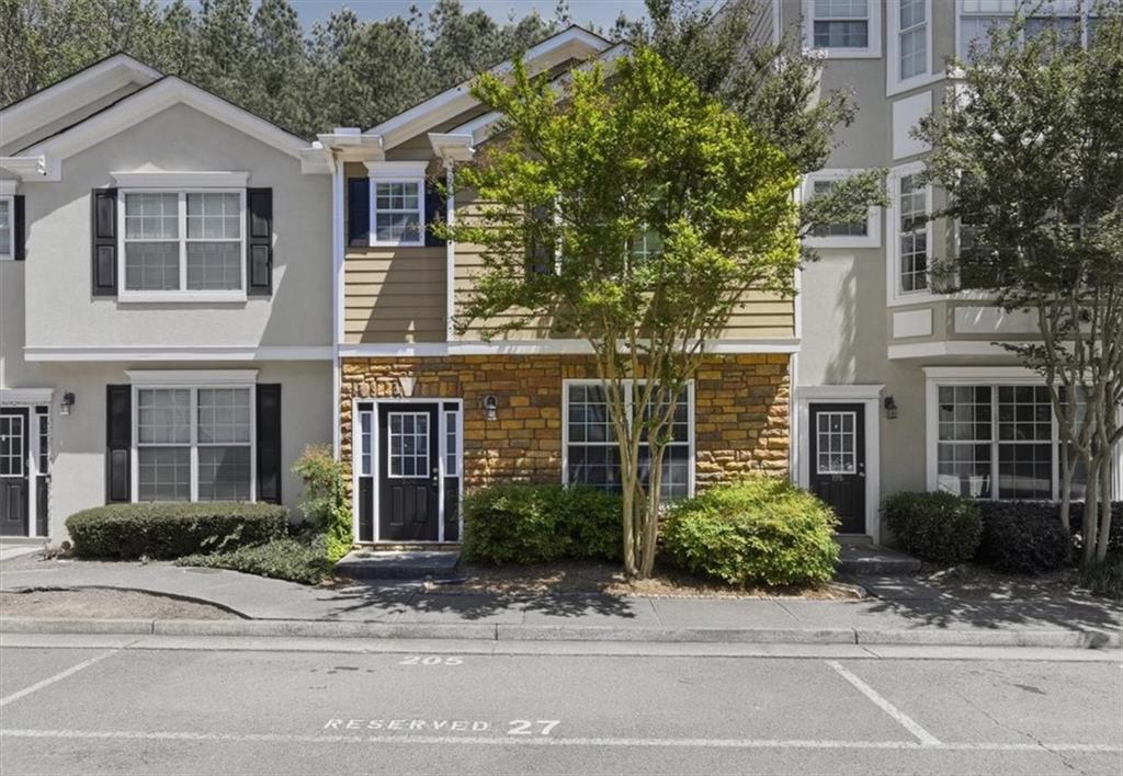 200 Riverstone Commons Circle Canton, GA 30114 - Photo 2 of 28 a front view of a house with a garden