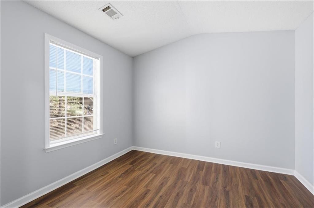 200 Riverstone Commons Circle Canton, GA 30114 - Photo 21 of 28 an empty room with wooden floor and windows