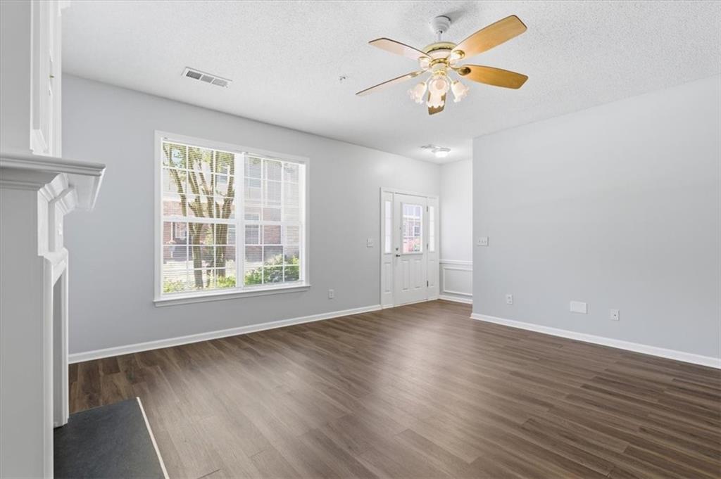 200 Riverstone Commons Circle Canton, GA 30114 - Photo 6 of 28 a view of an empty room with a window and wooden floor