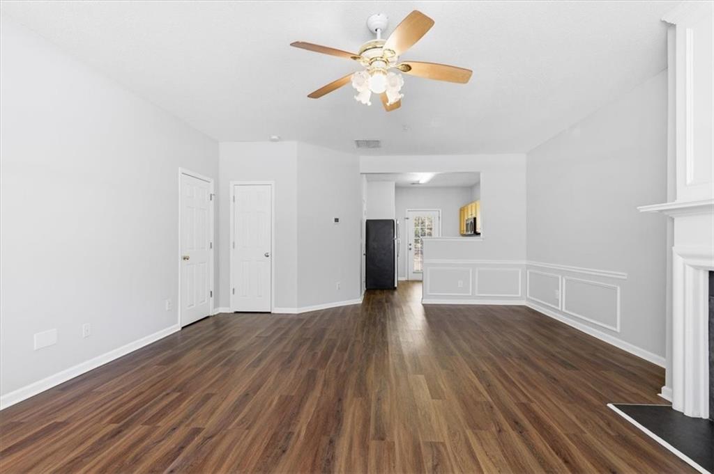 200 Riverstone Commons Circle Canton, GA 30114 - Photo 8 of 28 a view of an empty room with a window and wooden floor