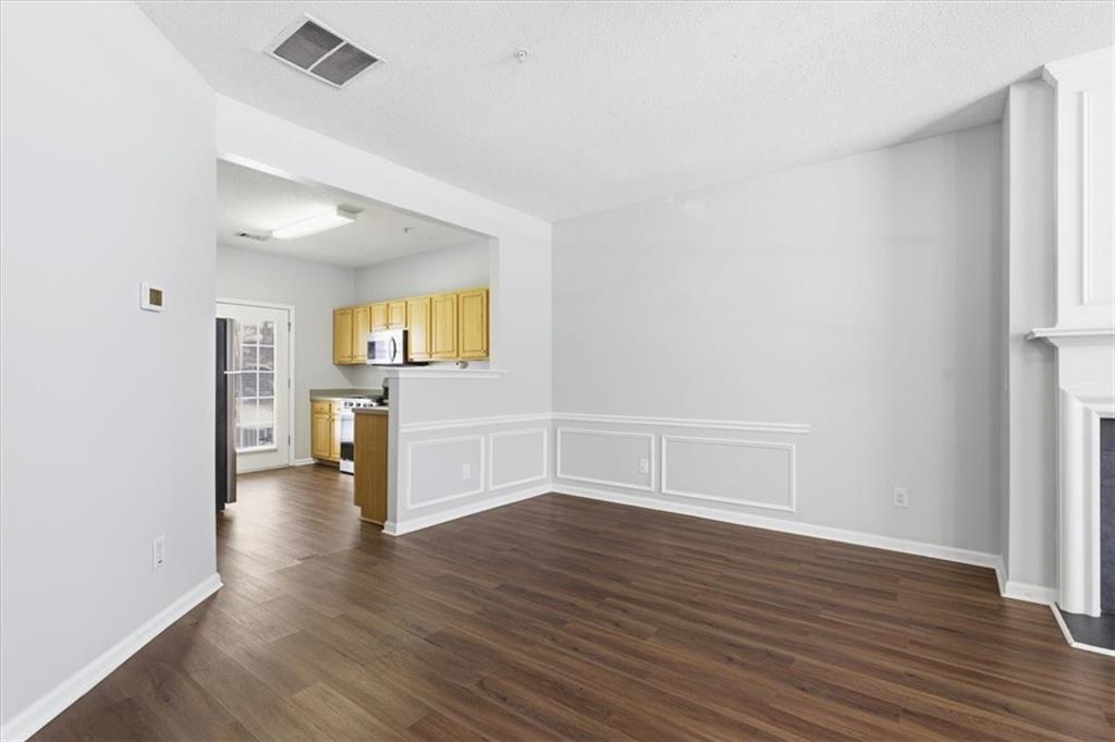 200 Riverstone Commons Circle Canton, GA 30114 - Photo 9 of 28 an empty room with wooden floor and windows
