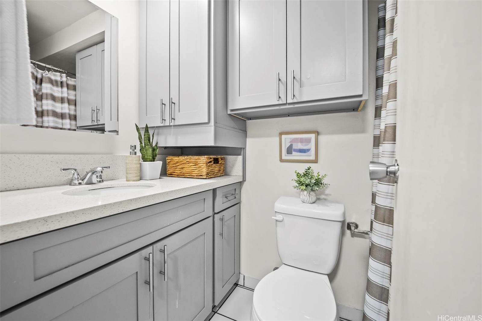 2888 Ala Ilima Street, Unit 2309 Honolulu, HI 96818 - Photo 8 of 18 Bathroom with newer cabinets and quartz counter.