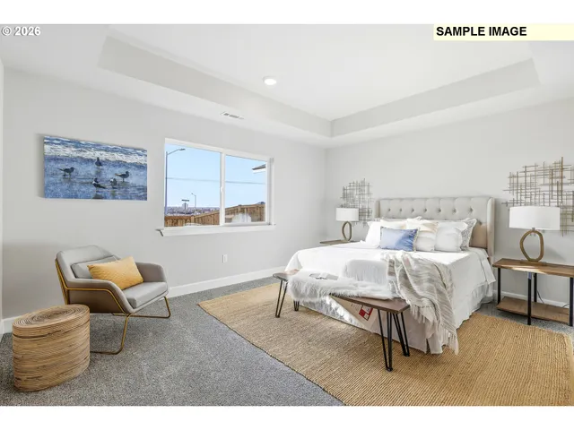 a bed room with a bed and a chair