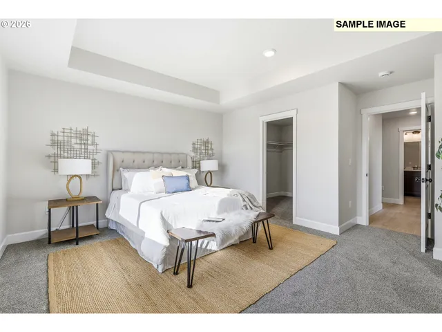 a living room with a bed furniture and a table