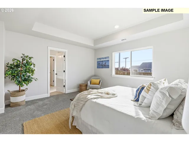 a bedroom with a bed and a potted plant