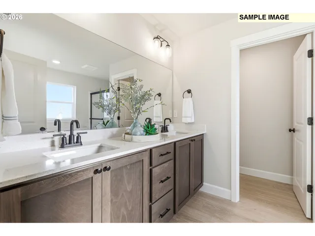 a bathroom with a double vanity sink and mirror