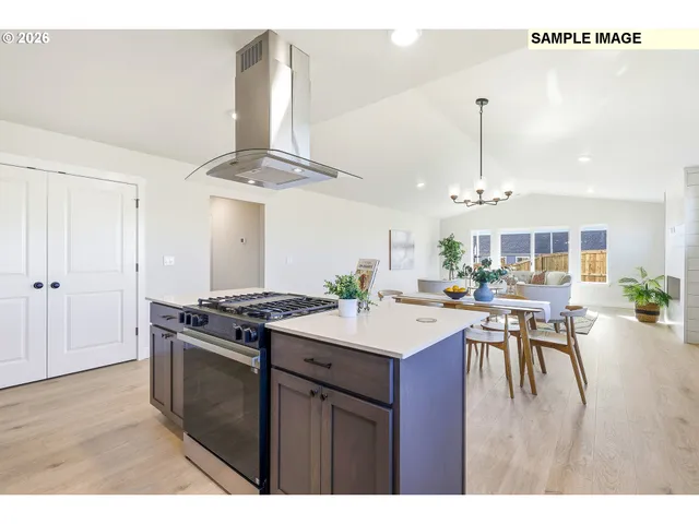 a kitchen with a stove a refrigerator and a dining table
