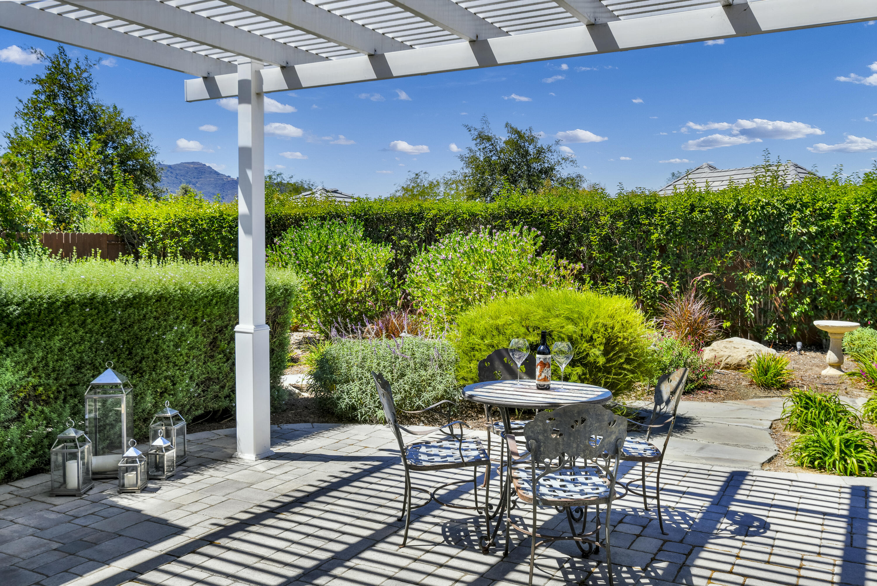 585 Valley Oak Road Solvang, CA 93463 - Photo 15 of 21 a patio with table and chairs and potted plants