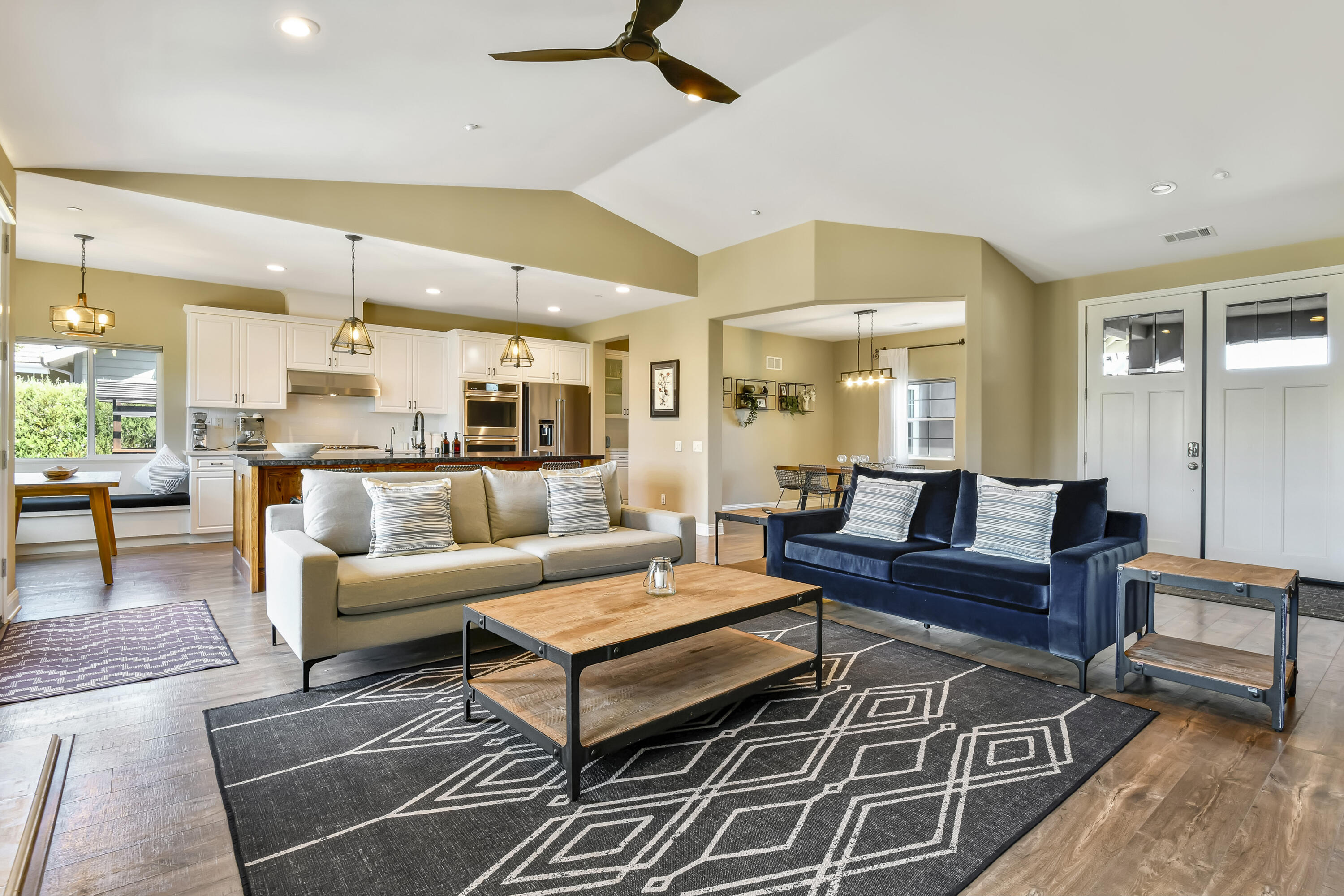 585 Valley Oak Road Solvang, CA 93463 - Photo 4 of 21 a living room with furniture a rug and a chandelier