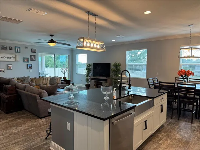 a kitchen with stainless steel appliances granite countertop a sink and a refrigerator